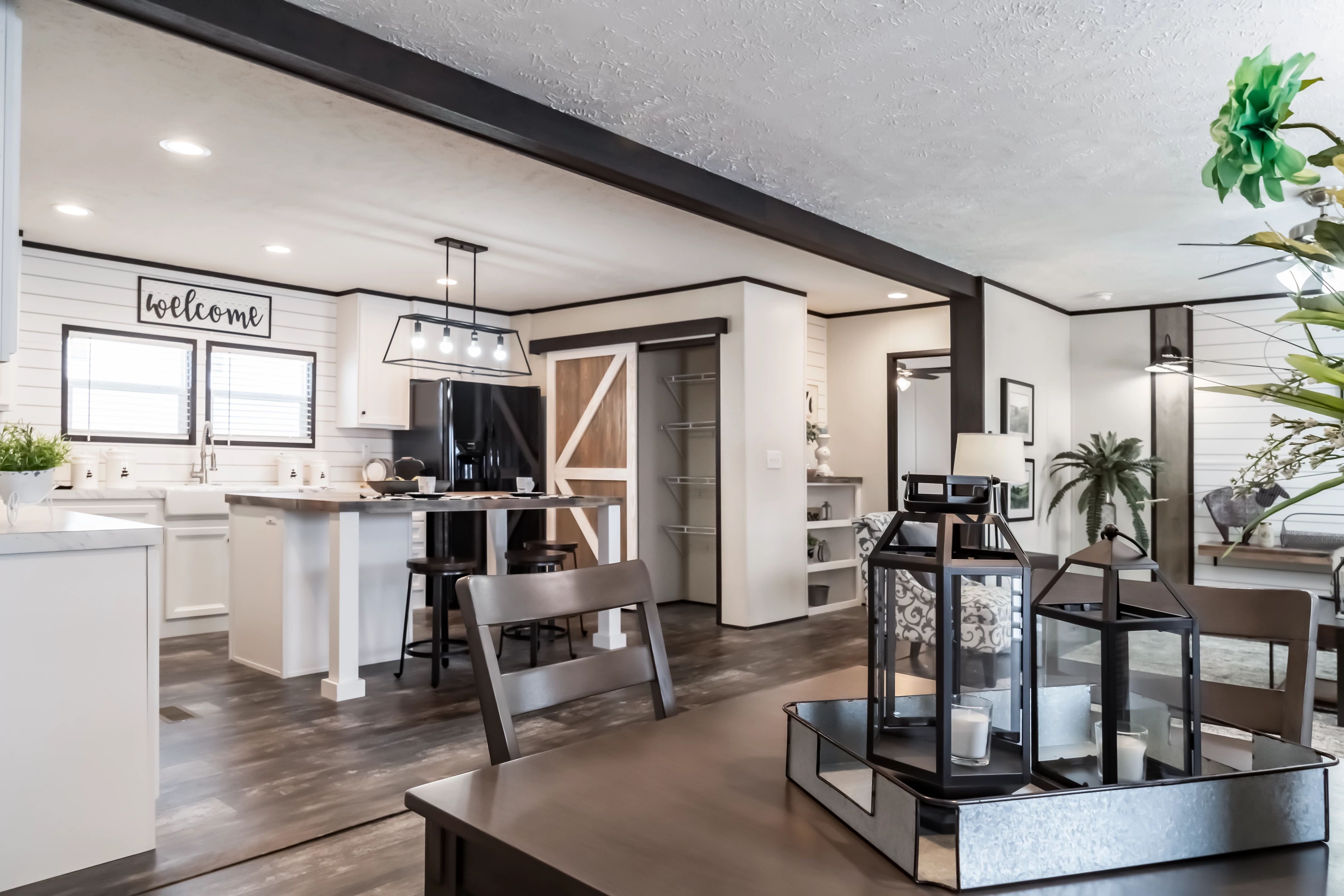 The spacious interior of a double-wide mobile home with an open floorplan.