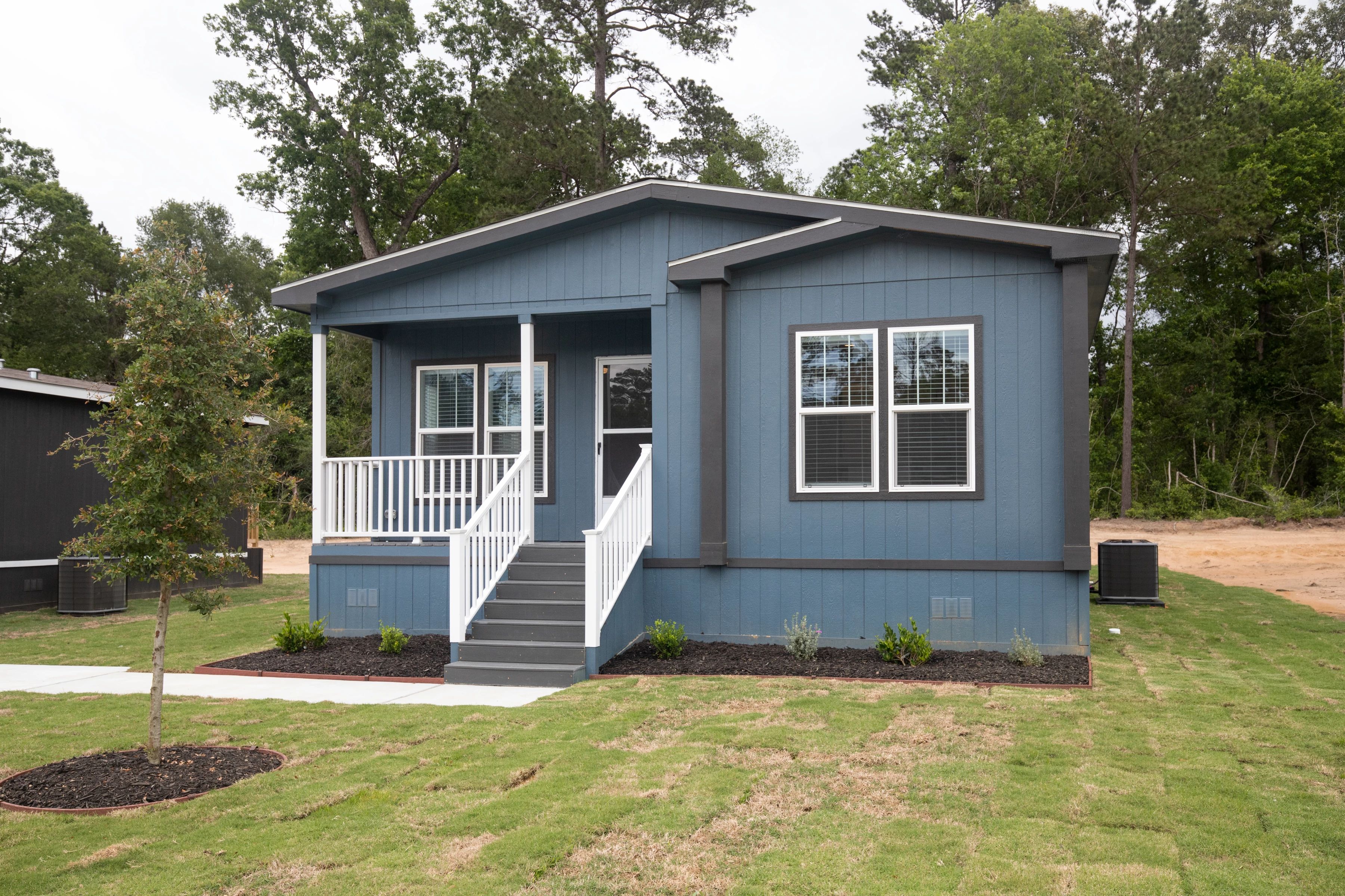  A blue manufactured home with a front porch financed with a chattel loan