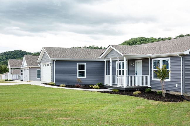 Two neighboring manufactured homes each with a two-car garage