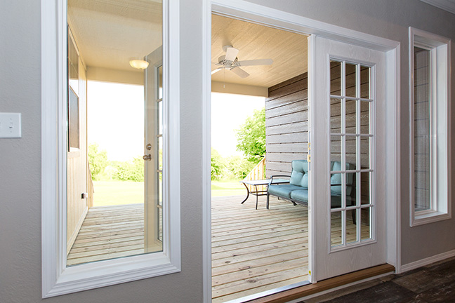 A covered porch of a manufactured home with outdoor seating